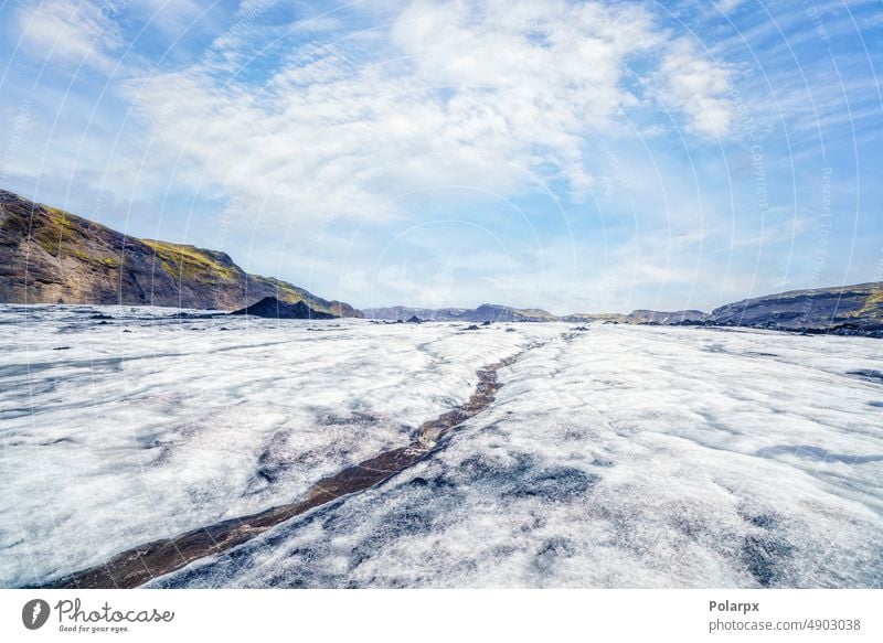 Icelandic glacier with a stream of melting water arctic scene stone frozen hiking mountain chilling coldness surface horizon sunset skies wild hike icelandic