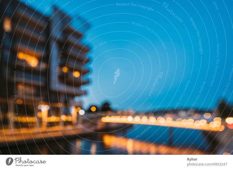 Oslo, Norway. Night Abstract Boke Bokeh Background Effect. Residential Multi-storey Houses In Aker Brygge District. Summer Evening. Famous Modern Residential Area