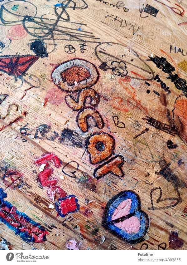 On an old table in a Lost Place somewhere, someone loves Oscar. I wonder if he has read it. Table Wooden table Tabletop Board writing Sign Colour photo Brown