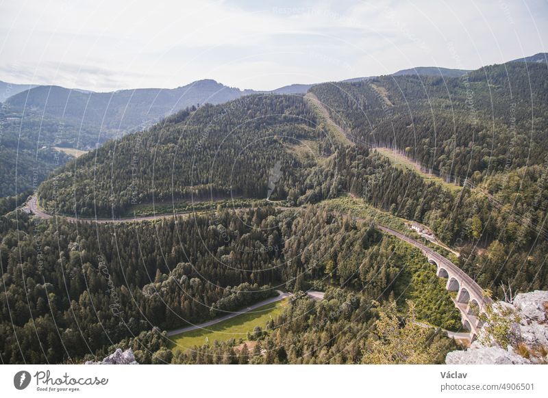 View from the rocky peak of Polleroswand of the Kalte Rinne railway viaduct and the railway cut into the mountainside, which belongs to the Rax-Schneeberg Group in the Styrian region of Austria