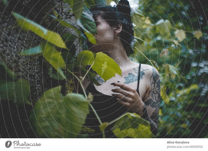 hiding portrait selfportraits Tattoos leaves Leaf green summer Dark Dark hair Grainy Long nails black nails fingers arm collar bones outside outdoors Skin woman