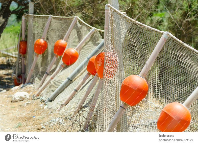 Fish fence with buoys deposited on land Buoy Rod wickerwork Storage area coarse-meshed float gear Structures and shapes Fishery fishing storage Sunlight