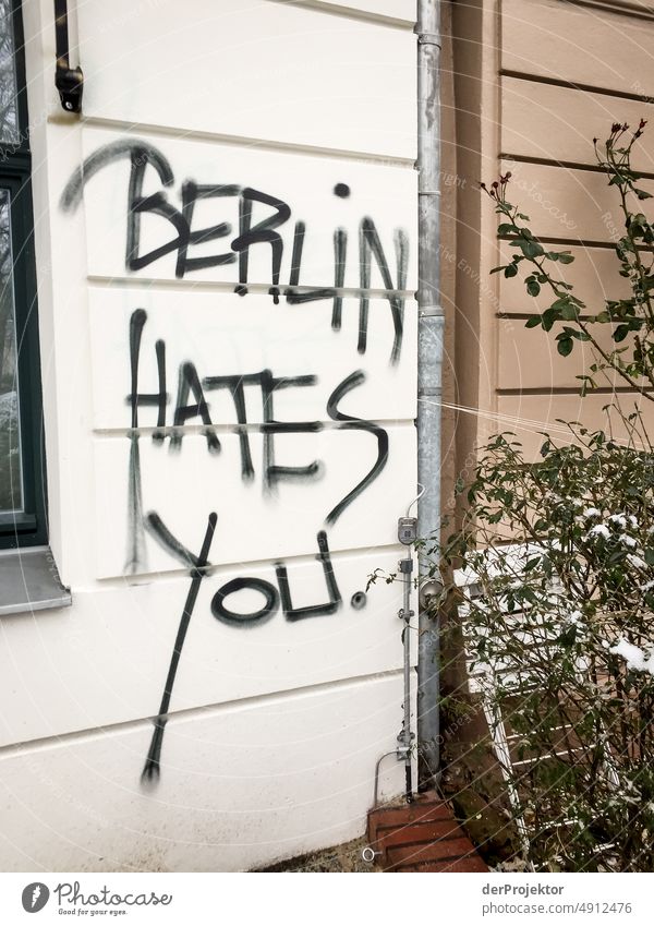 Wall with message: "Berlin hates you". Exterior shot Gloomy real estate Multicoloured Copy Space left Copy Space bottom Real estate market house purchase