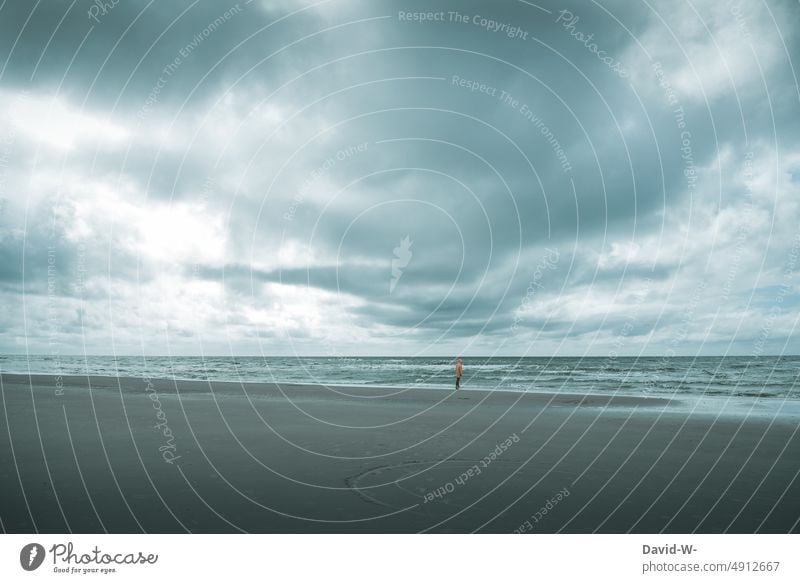 Man standing on the beach in the distance watching the rough sea Ocean Gale Waves Nordic coast Baltic Sea North Sea Observe Beach Vacation & Travel Water