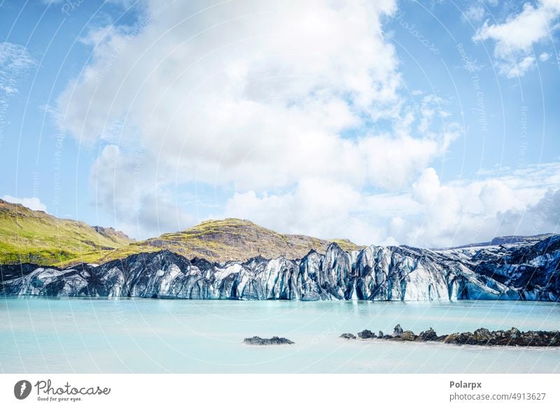 Melting glacier in Iceland with turquoise water lava rock ice geology scene landscape scenery melting wilderness dramatic geological sky excursion icecap