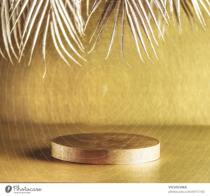 Golden modern product display with podium and silver palm leaves. Luxury backdrop golden luxury scene stage presentation front view copy space advertising