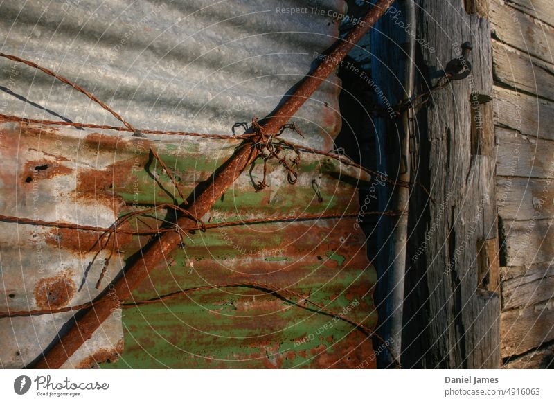 Old rusty farm gate Farm Gate Rural Corrugated sheet iron Metal Timber Exterior shot Wire Chain Farm scene Weathered weathered wood old Rust Iron