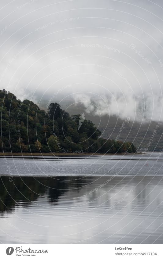 low hanging clouds in scottish glen Landscape Clouds Lake Scotland reflection Dark trees Water reflection depth Waves low clouds Fog Calm Threat relaxing