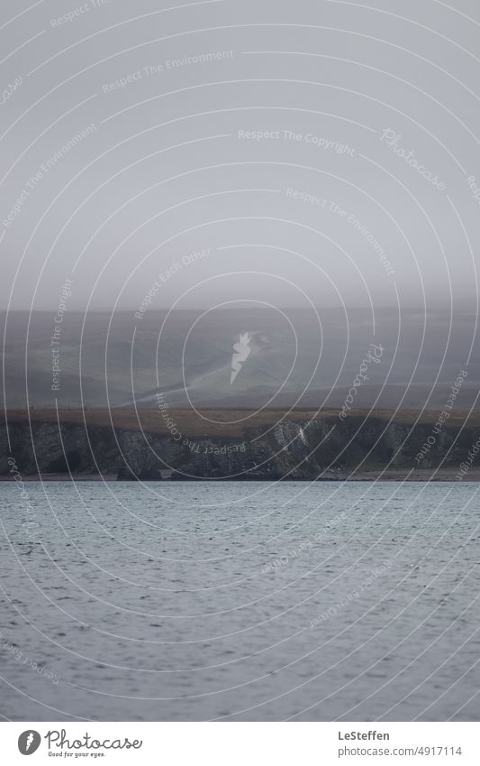 Scottish coast and path in the fog Ocean turbulent water Waves depth blur steep coast Fog grey sky Calm Scotland dark and moody Dark Threat Cold tranquillity