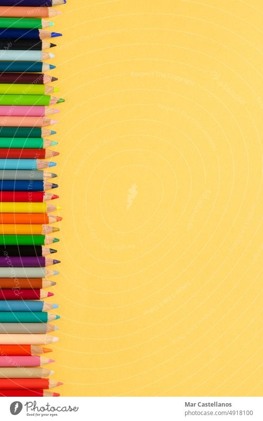 Back to class. Coloured pencils on yellow background. Copy space. Vertical photo. Back to school envelope Top view copy cream pastel education primary secondary