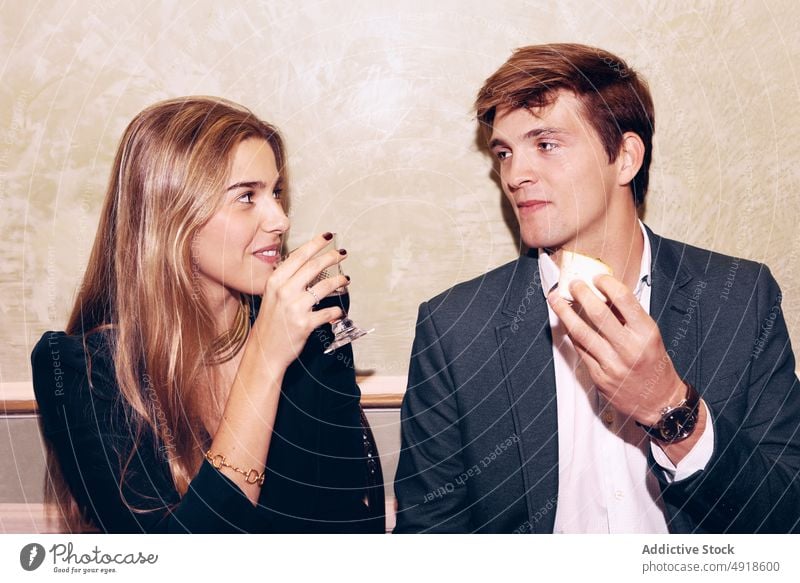 Cheerful couple eating in restaurant drink cheerful having fun together wine food appetite dinner hungry alcohol booze aperitif tasty taste delight delicious