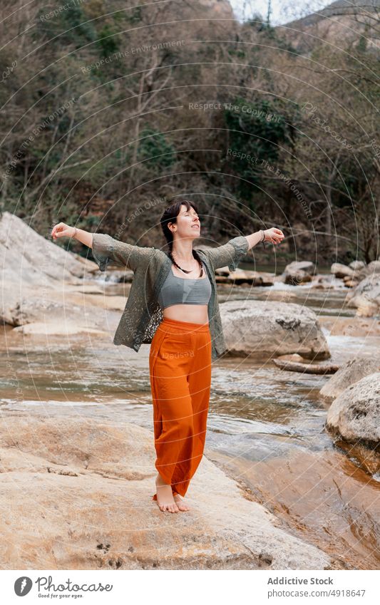 Young woman having fun in the river forest vacation lifestyle nature travel young stones outdoor people leisure activity adventure lake hike holiday tourism