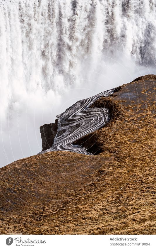 Amazing landscape of waterfall and rocky ravine in Iceland canyon nature breathtaking cliff scenery gorge stream energy power grass picturesque dettifoss