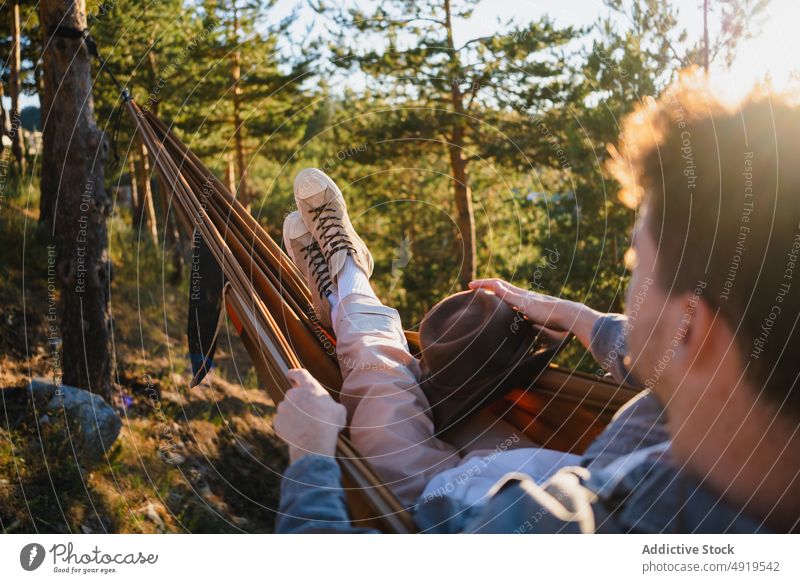 Man resting in hammock in nature man forest relax recreation woods leisure chill pastime headwear tree hat male summer plant sunshine journey summertime trendy