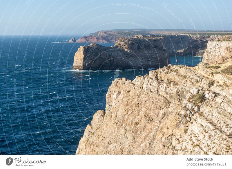 Rough rocks in blue ocean under cloudy sky nature highland landscape algarve seascape horizon blue sky geology majestic formation rough endless portugal bumpy