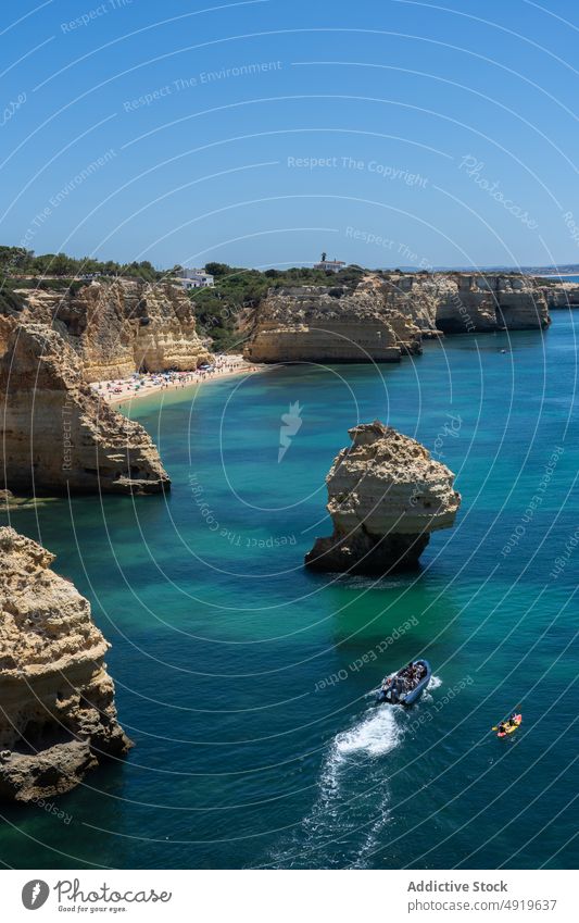 Top view anonymous people on a boat and kayak sea canoe water ocean beach vacation outdoor travel two aerial view top view from above activity kayaking leisure