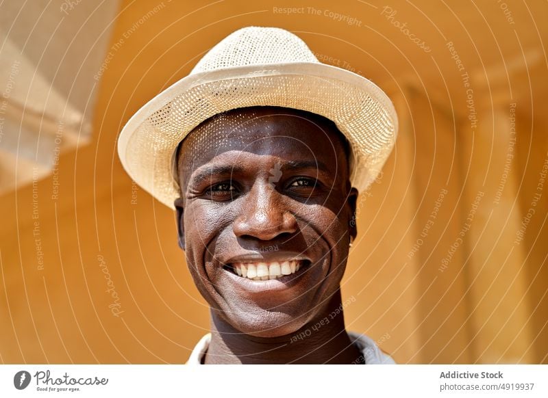 Portrait of black man standing on street businessman building appearance style city urban pathway district outfit african american sidewalk walkway content glad