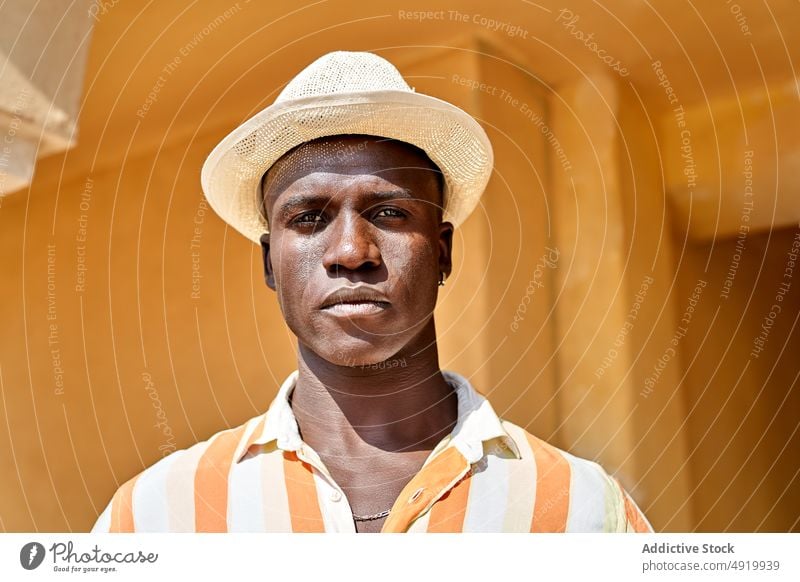 Portrait of black man standing on street businessman building appearance style city urban pathway district outfit african american sidewalk walkway content glad