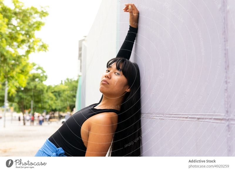 Asian female dancer bending back woman backbend street wall grace building perform arms raised young ethnic asian energy style talent daytime skill practice