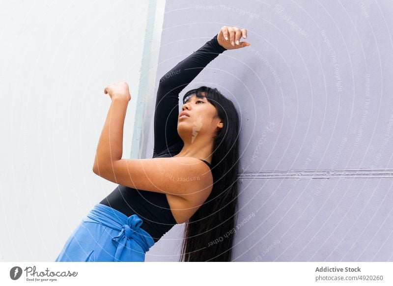 Asian female dancer bending back woman backbend street wall grace building perform arms raised young ethnic asian energy style talent daytime skill practice