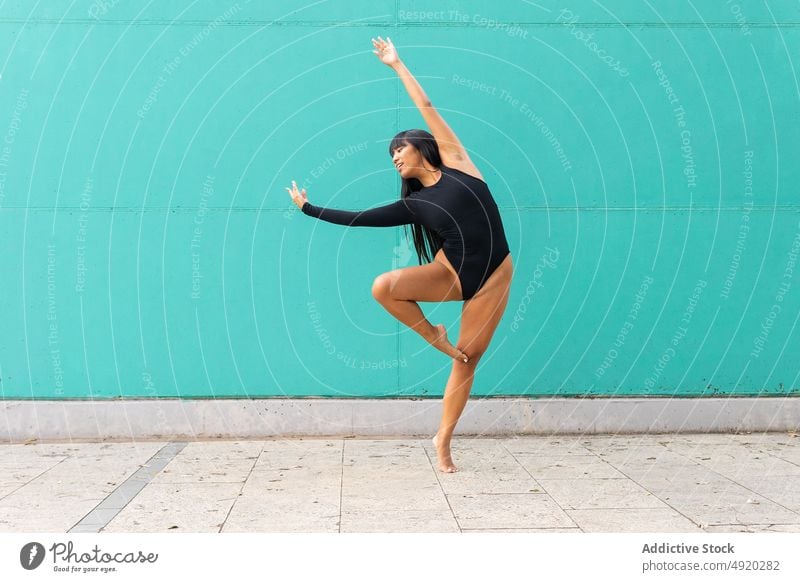 Barefoot Asian ballerina dancing on street woman dance pavement bend grace balance perform wall female young ethnic asian smile practice dancer ballet skill