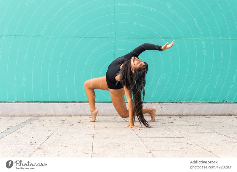 Barefoot Asian ballerina dancing on street woman dance pavement bend grace balance perform wall female young ethnic asian smile practice dancer ballet skill