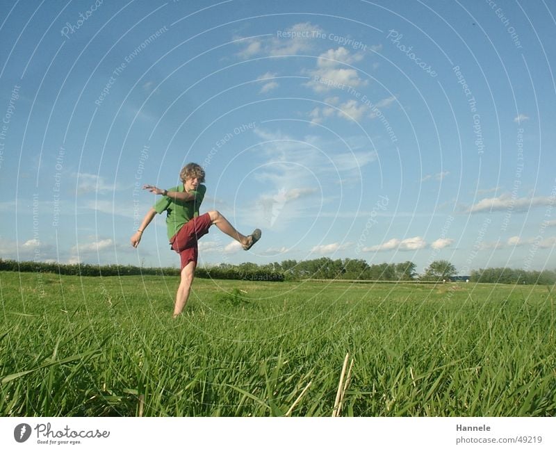 free kick Playing Clouds Meadow Green Masculine Summer Fluid Exterior shot Sky Ball Shot Sun Joy Curl Landscape Nature Freedom