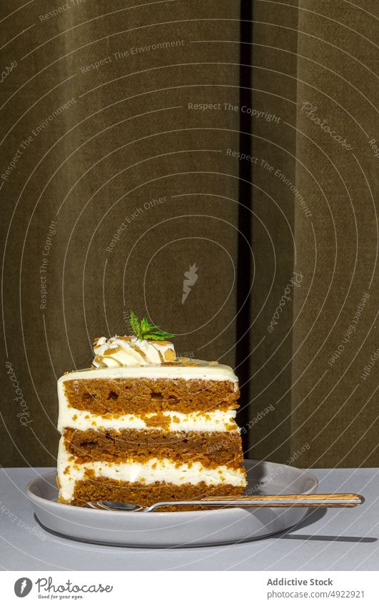 Slice of tasty carrot cake sweet dessert flavor confection treat slice pastry sponge indulge calorie yummy baked mint serve plate table spoon delicious food