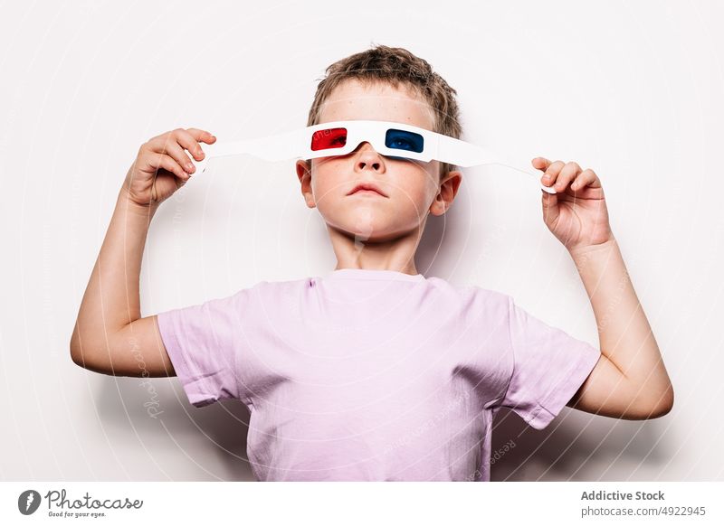 Boy with colorful 3D glasses boy 3d kid entertain vision amusement childhood hobby cardboard casual studio optical adorable style appearance sweet