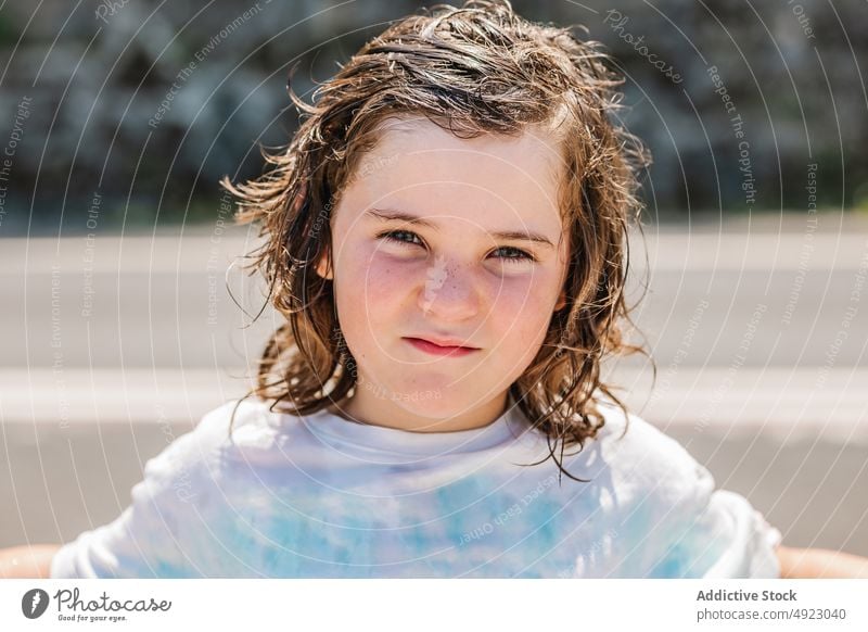 Cute girl with wet hair on street kid summer appearance childhood style portrait road getaria zarautz spain roadway casual t shirt innocent cute sunshine gaze