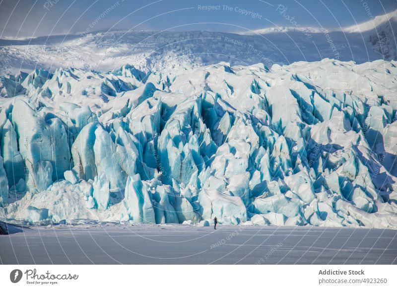 Traveler admiring spectacular scenery of frozen seashore winter person ice hike traveler hiker landscape beach cold glacier iceland admire explorer coast