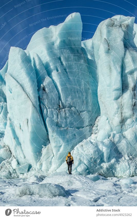 Traveler admiring spectacular scenery of frozen seashore winter person ice hike traveler hiker landscape beach cold glacier iceland admire explorer coast