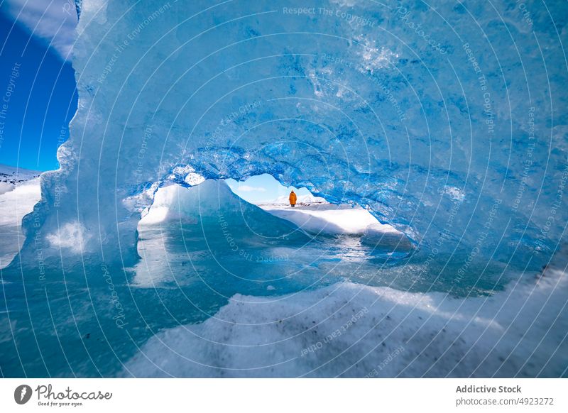 Traveler admiring spectacular scenery of frozen seashore winter person ice hike traveler hiker landscape beach cold glacier iceland admire explorer coast