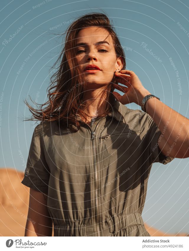 Woman standing in desert area woman nature trip travel adventure journey pastime tourist feminine lut confident summer style traveler flying hair wind female