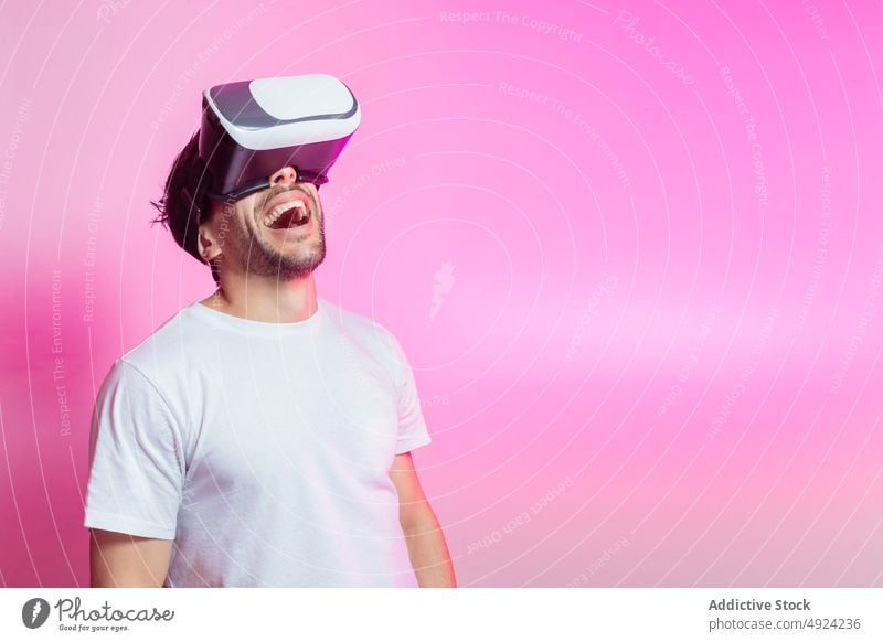 Cheerful man in VR glasses celebrating success vr virtual reality cyberspace futuristic high tech victory win celebrate gamer modern achieve triumph positive