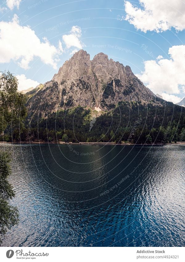 Scenic mountain lake against sky in Spain river landscape nature forest range Aiguestortes valley Estany of Saint Maurici scenery San Mauricio tree lakeside