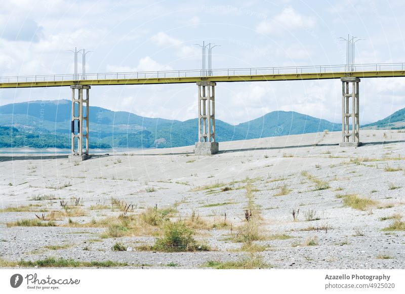 Yellow bridge over the dam architecture beach block blue building change climate clouds coast coastline concrete danger ecology editorial empty environment