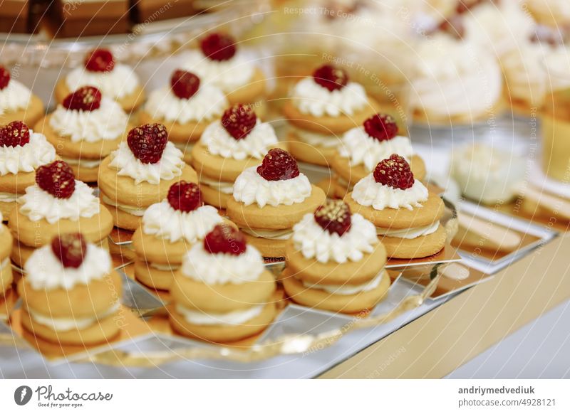 Wedding candy bar table. Cakes with cream and berries and other sweets. High quality photo dessert background food party decoration gourmet tasty white cake