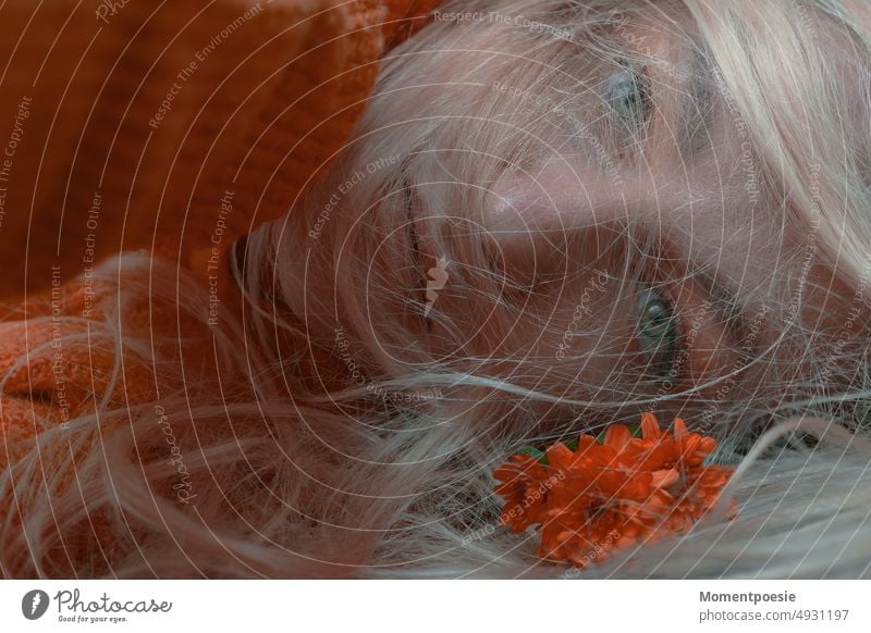 lying blonde woman in orange knitted sweater with orange flowers in foreground Orange Blonde Lie sad Flower Autumn Autumnal autumn blues winter blues