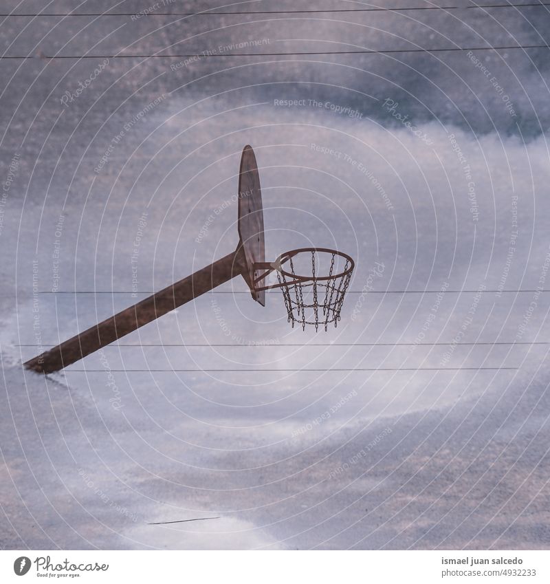 street basket hoop reflected on the puddle on the ground basketball reflection silhouette water rain rainy court field floor sport play playing park playground