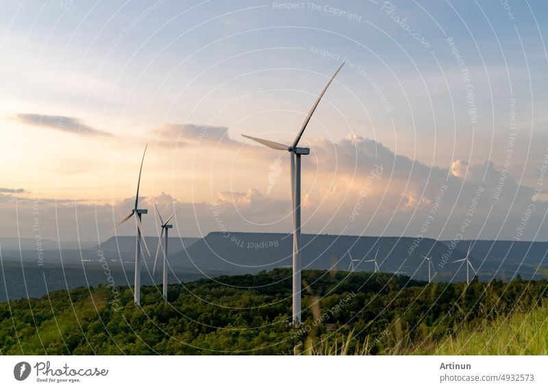 Wind energy. Wind power. Sustainable, renewable energy. Wind turbines generate electricity. Windmill farm on mountain with sunset sky. Green technology. Renewable resource. Sustainable development.