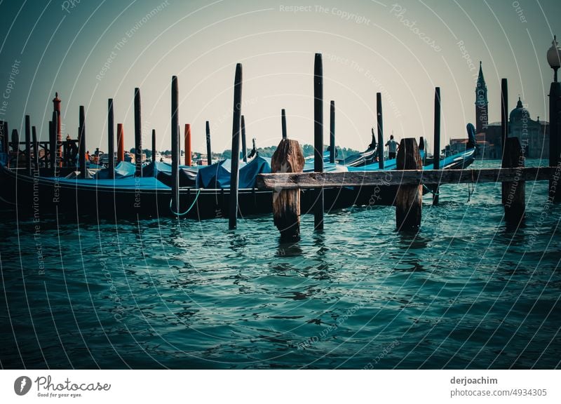 It's closing time. The gondoliers have covered their gondolas and tied them to wooden poles. Gondola (Boat) Town Watercraft Tourism Exterior shot Italy Venice