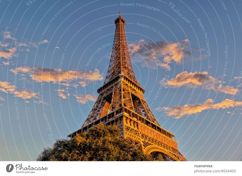 Image of the Eiffel Tower from the base, worm's eye view, against the blue sky and evening light above it Paris France cityscape famous symbol france romantic