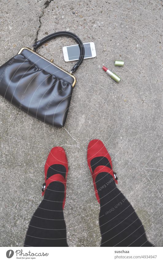 woman stands in front of dropped handbag together with contents that have tumbled out Woman Legs feminine feet High heels Feminine bimbo Lady ladylike Handbag