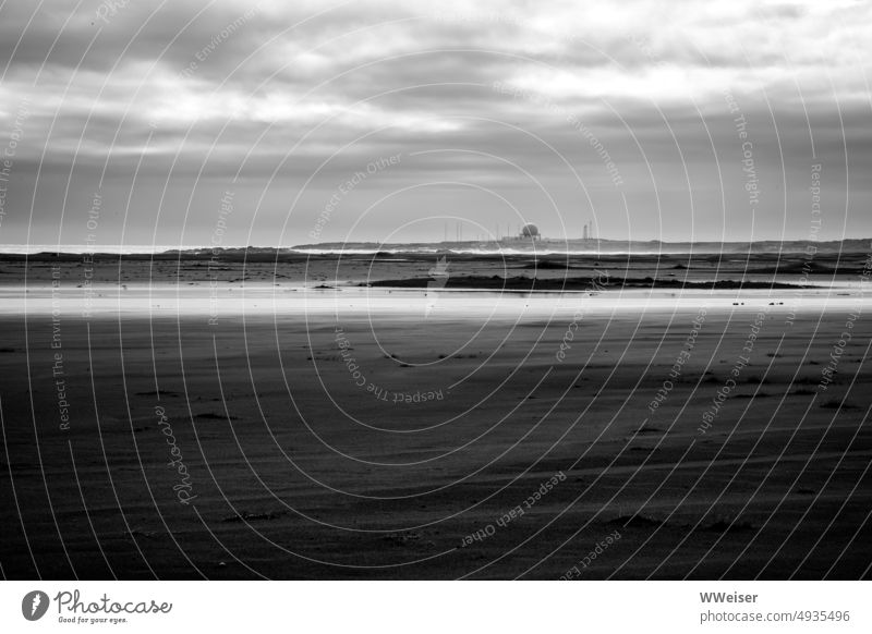 In the distance there is a mysterious building like a measuring station coast Ocean ocean somber Apocalyptic sentiment Gray Dark Beach Sand Water Clouds Rough