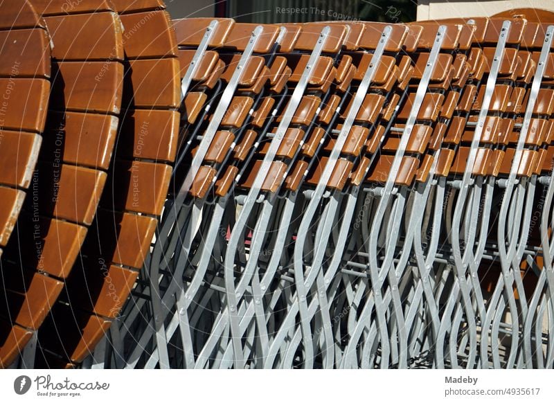 Folding brown tables and chairs for outdoor catering in the spring sunshine in the alleys of the old town of Osnabrück in Lower Saxony decorations Wood Brown