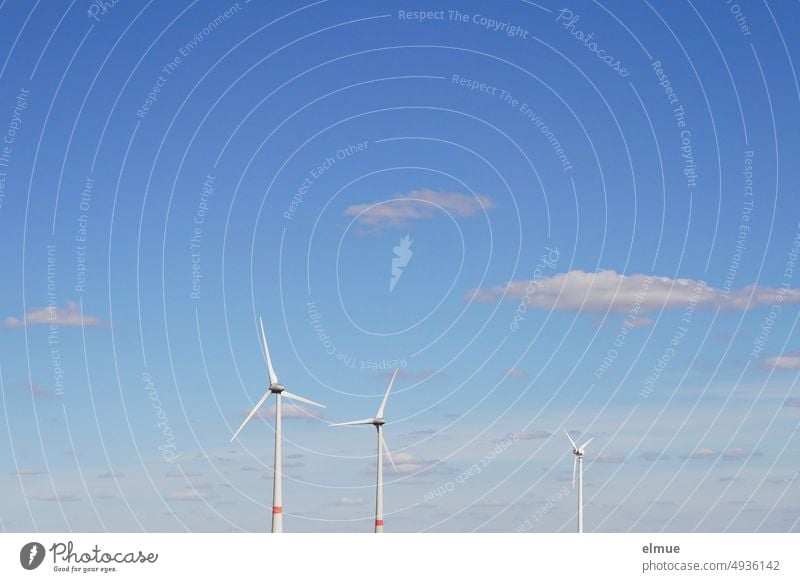 three wind turbines in front of blue sky with single fair weather clouds / wind energy Pinwheel Wind energy plant wind power Renewable energy eco-power