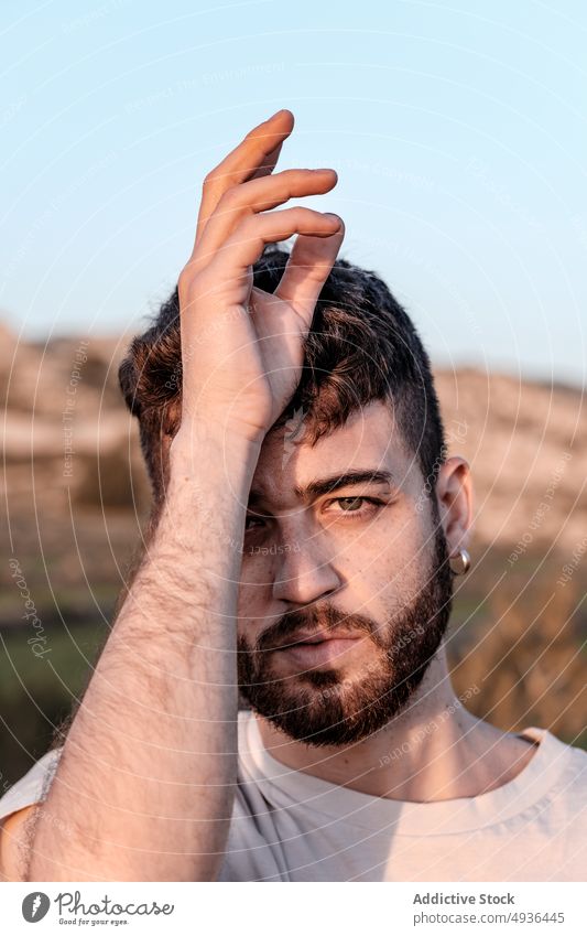 Bearded man touching Crown chakra crown chakra yoga hill calm countryside summer zen blue sky male young sahasrara beard spirit personality peaceful wellbeing