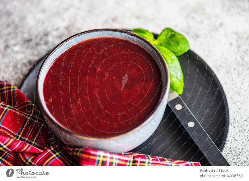 Beetroot cream soup with basil beet beetroot black bowl ceramic concrete diet eat eating food healthy meal organic served spicy table textured vegan vegetable