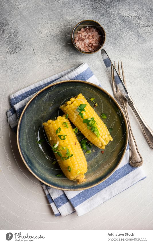 Boiled corn with salt and green onion boiled bowl cooked diet eat food healthy himalayan salt juicy meal corncob organic pink salt served plate tasty vegan